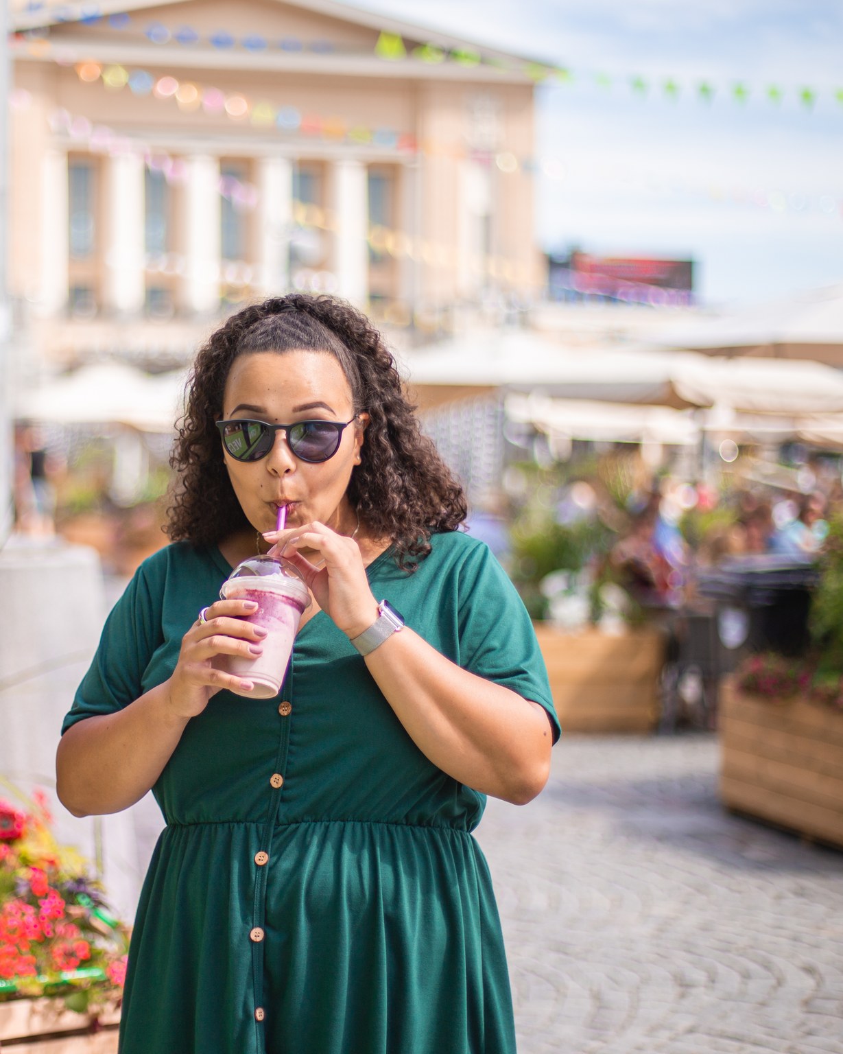 A person sipping a smoothie at the summer terrace restaurants.